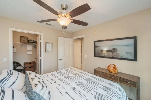 a bedroom with bed and a chandelier