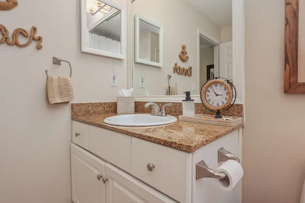 a view of kitchen island with granite countertop a sink a stove and dishwasher