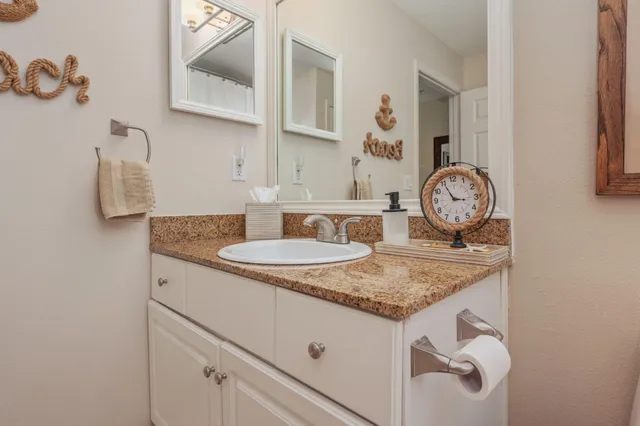 a view of kitchen island with granite countertop a sink a stove and dishwasher