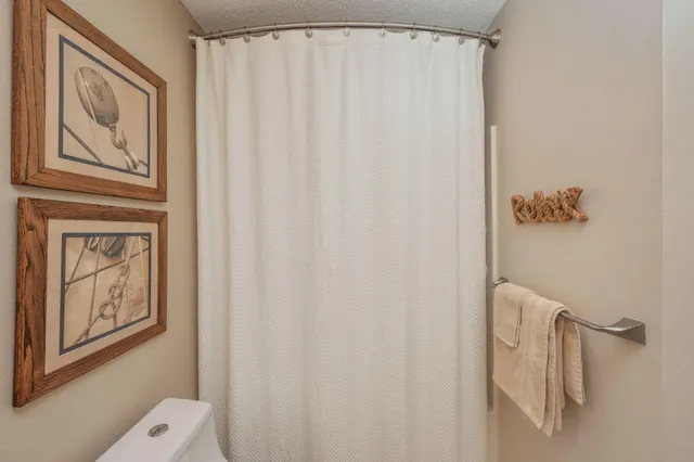a bathroom with a shower curtain and a window