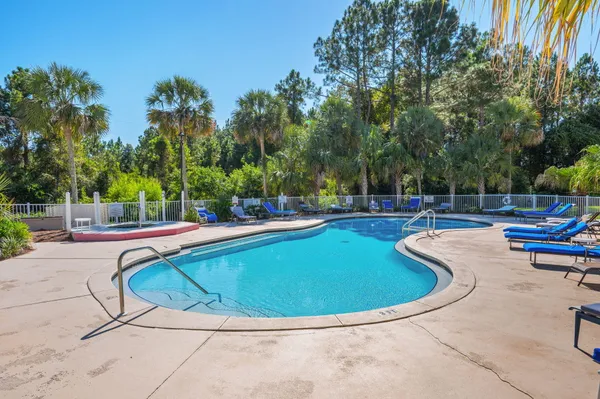 a view of a swimming pool with outdoor seating