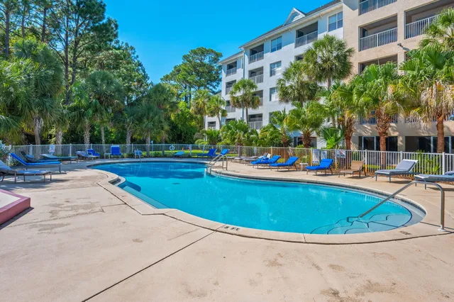 a view of swimming pool with outdoor seating and plants