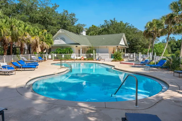 a view of a swimming pool with lounge chairs