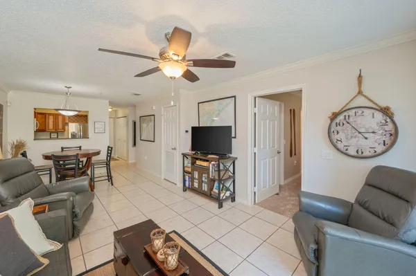a living room with furniture a couch and a flat screen tv