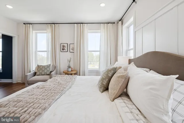 a bedroom with a large bed and a large window