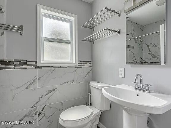 169 Center Street North Baldwin, FL 32234 - Photo 12 of 15 a bathroom with a sink a toilet and shower