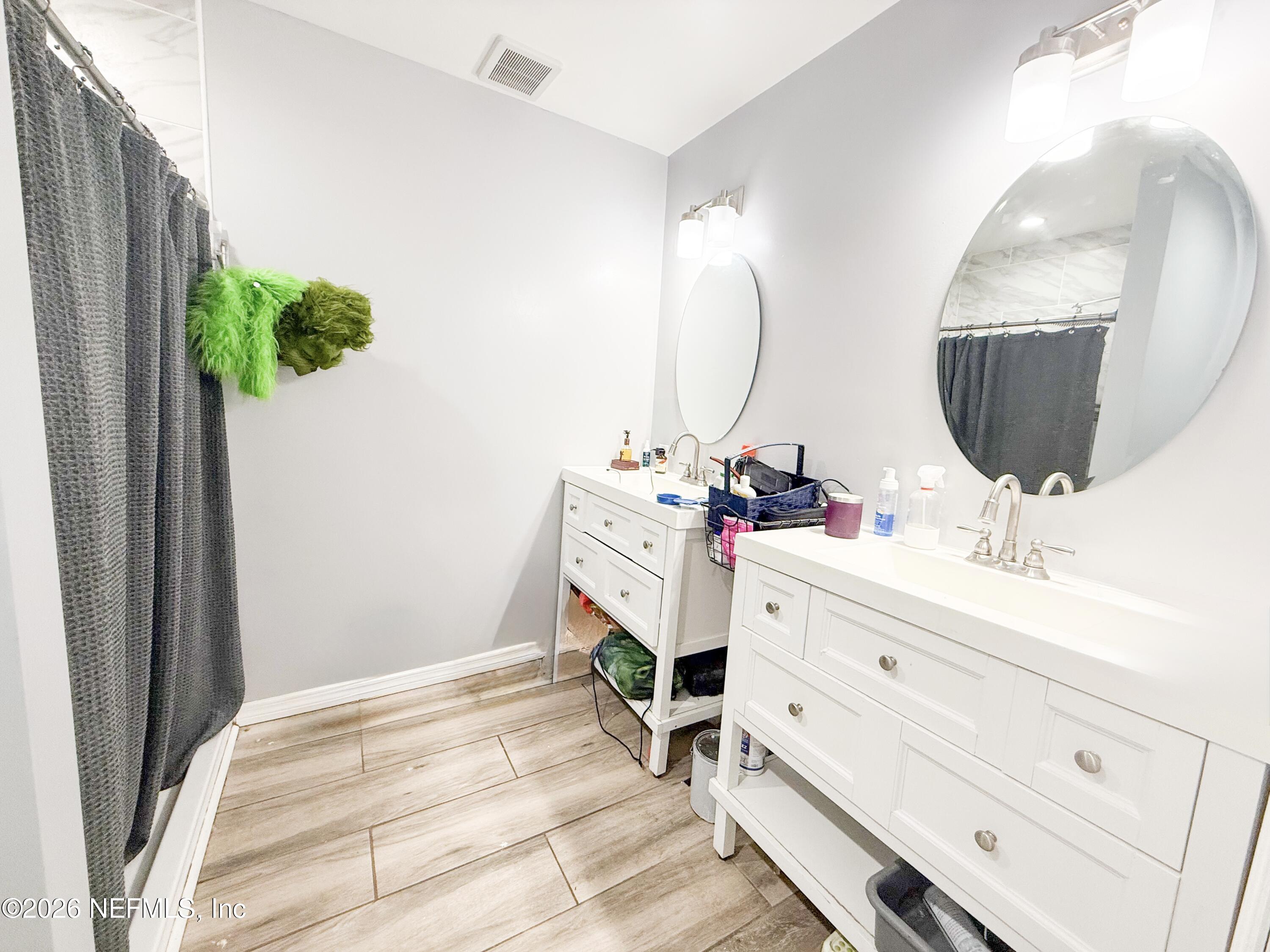 169 Center Street North Baldwin, FL 32234 - Photo 9 of 15 a bathroom with a sink vanity and mirror