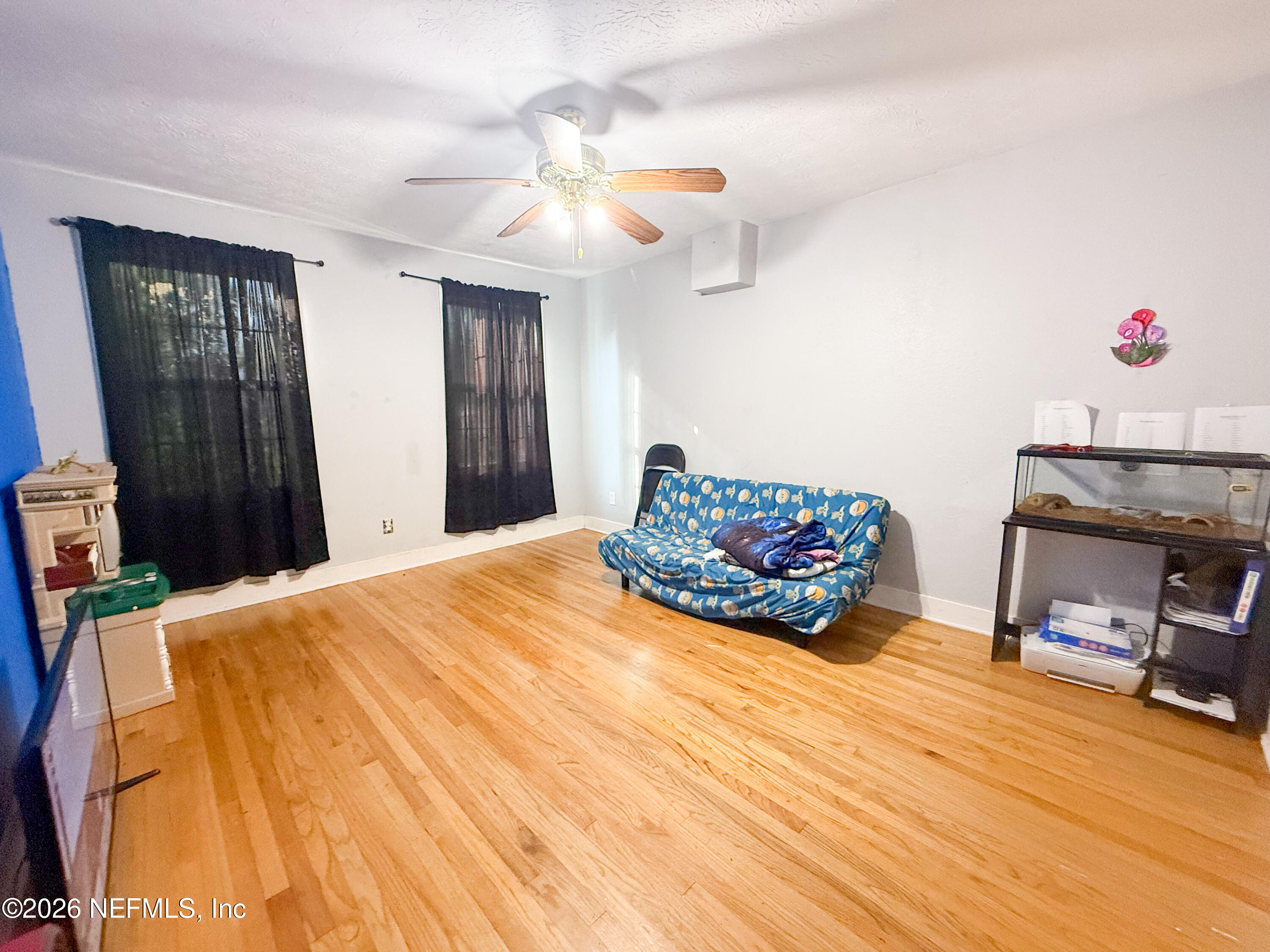 169 Center Street North Baldwin, FL 32234 - Photo 10 of 15 a bedroom with a bed and a chandelier