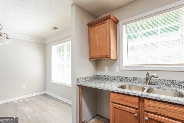 a kitchen with stainless steel appliances granite countertop a sink and a window