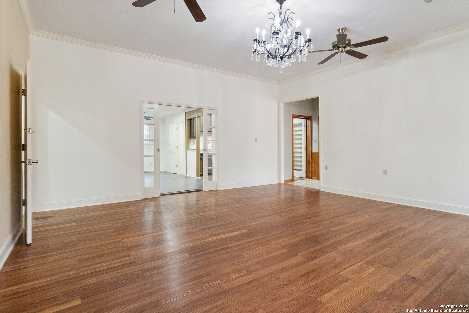 19517 Scenic Loop Road Helotes, TX 78023 - Photo 13 of 55 a view of an empty room with wooden floor and a window