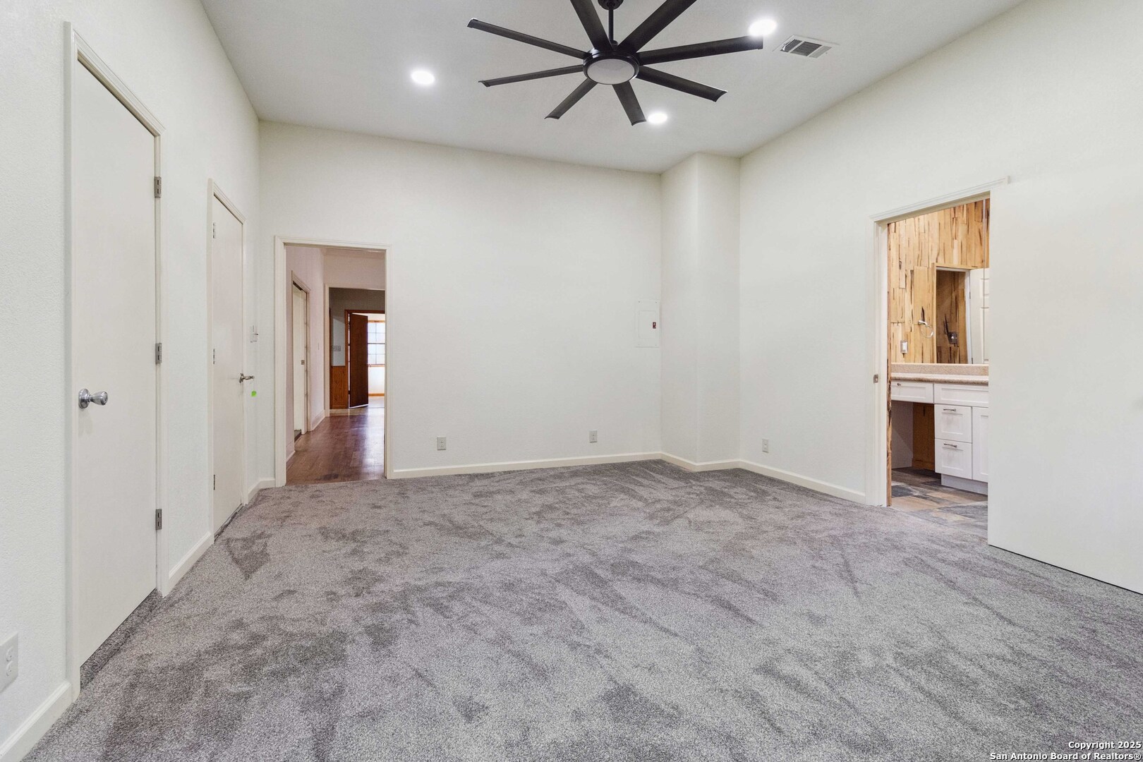 19517 Scenic Loop Road Helotes, TX 78023 - Photo 19 of 55 an empty room with windows and fan