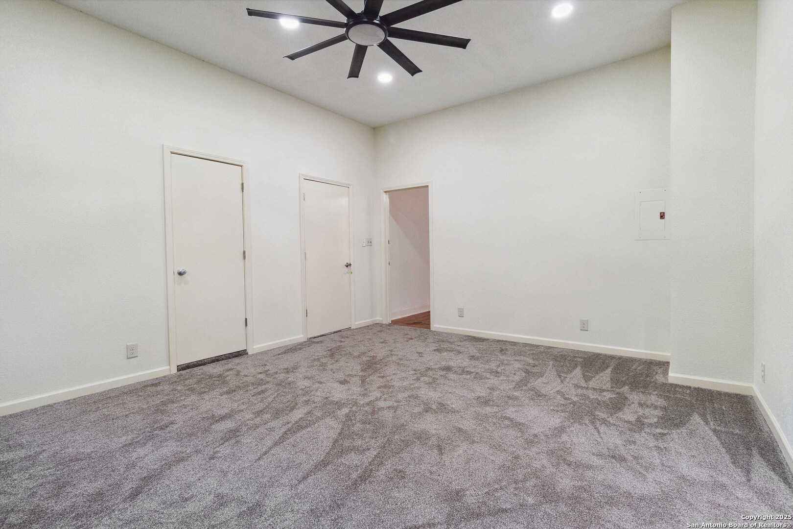 19517 Scenic Loop Road Helotes, TX 78023 - Photo 20 of 55 an empty room with a ceiling fan and fan
