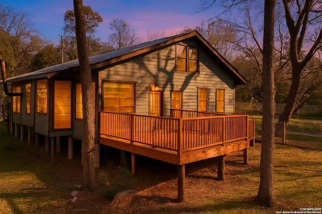a view of a house with a yard patio and fire pit