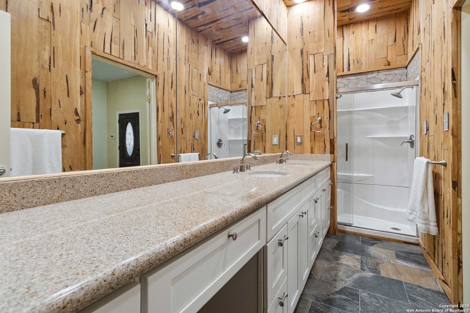19517 Scenic Loop Road Helotes, TX 78023 - Photo 21 of 55 a bathroom with a granite countertop sink and a mirror