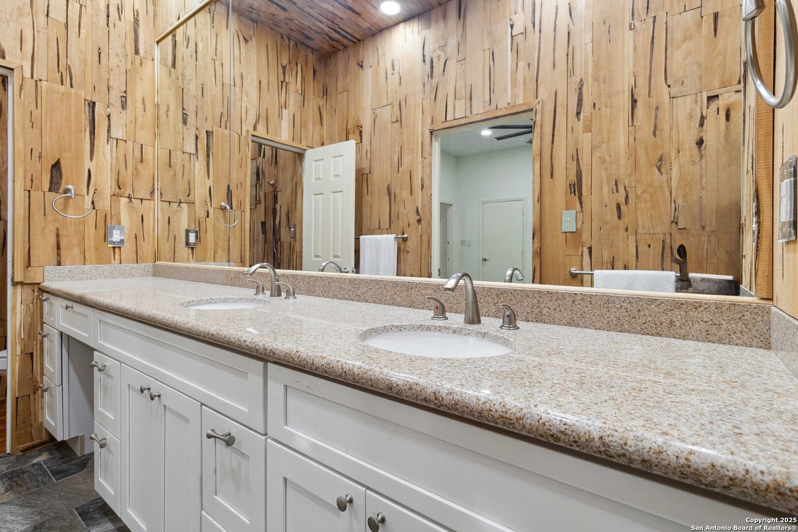 19517 Scenic Loop Road Helotes, TX 78023 - Photo 22 of 55 a bathroom with a granite countertop sink and a mirror