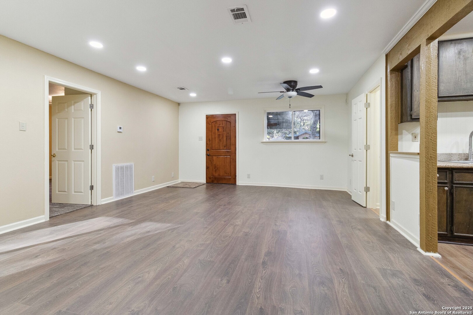 19517 Scenic Loop Road Helotes, TX 78023 - Photo 23 of 55 an empty room with wooden floor and windows