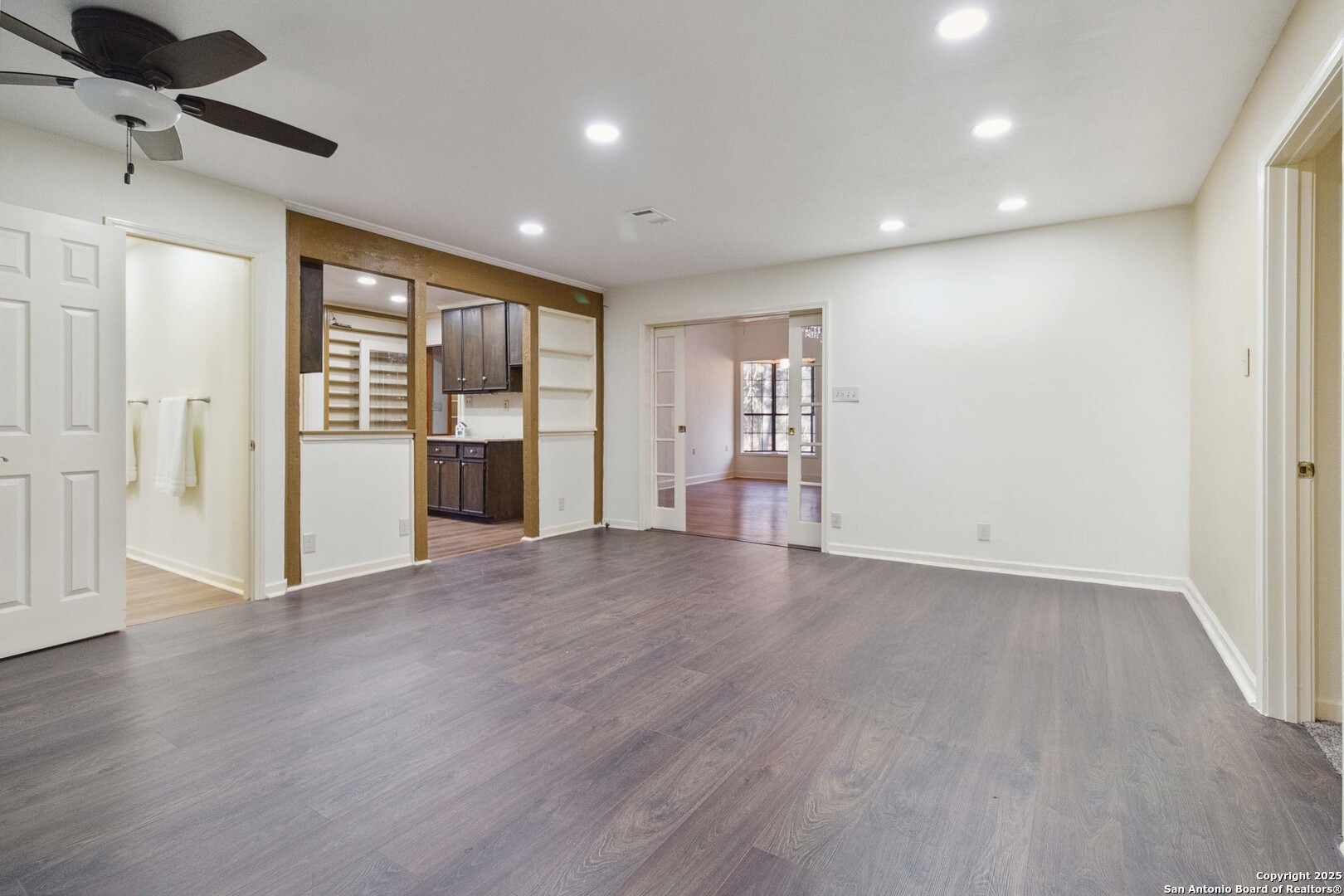 19517 Scenic Loop Road Helotes, TX 78023 - Photo 24 of 55 a view of an empty room with a window and wooden floor