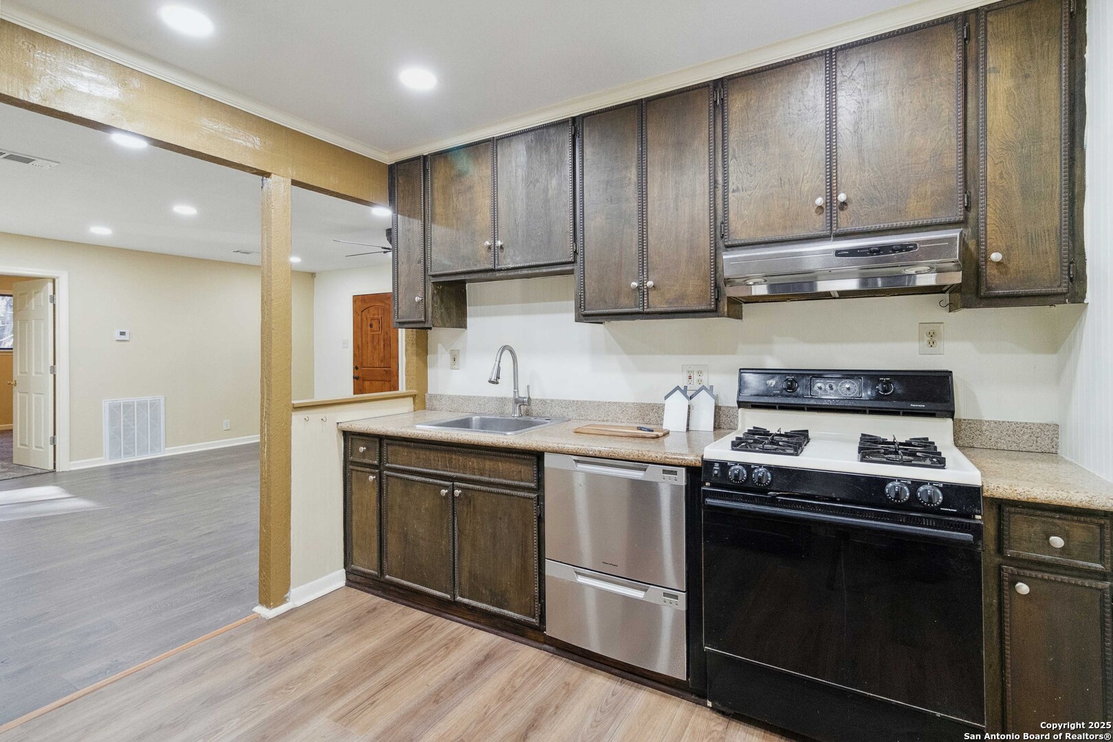 19517 Scenic Loop Road Helotes, TX 78023 - Photo 29 of 55 a kitchen with wooden cabinets and stainless steel appliances