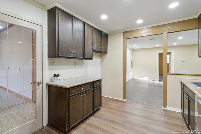 a room with a wooden floor and a sink
