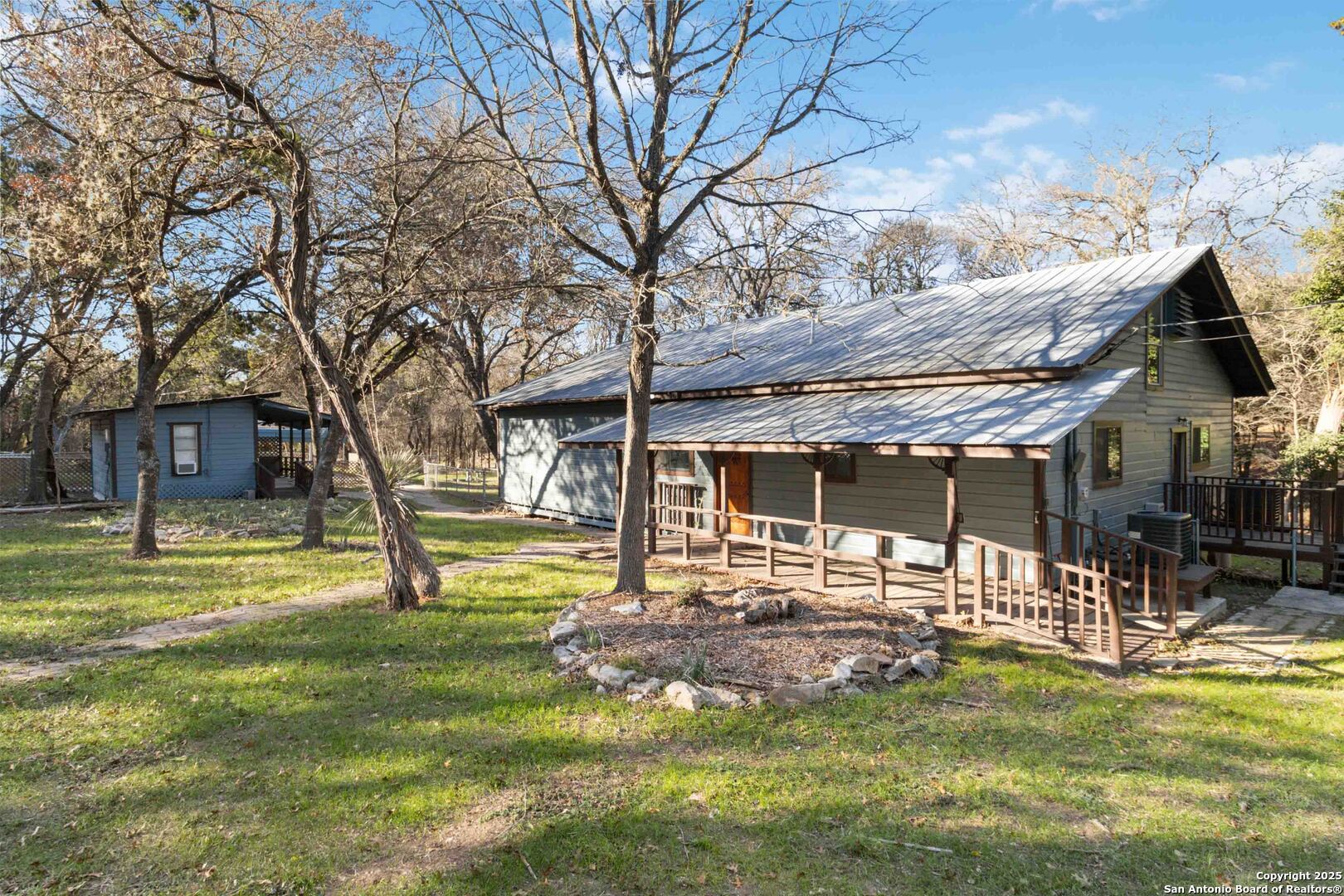 19517 Scenic Loop Road Helotes, TX 78023 - Photo 3 of 55 a view of a house with a yard patio and fire pit