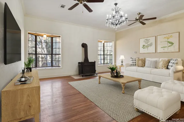 a view of a house with a big yard and large trees