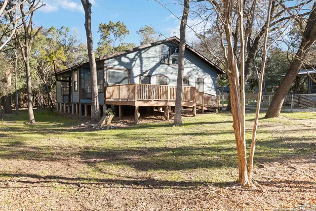 a view of a yard with large trees