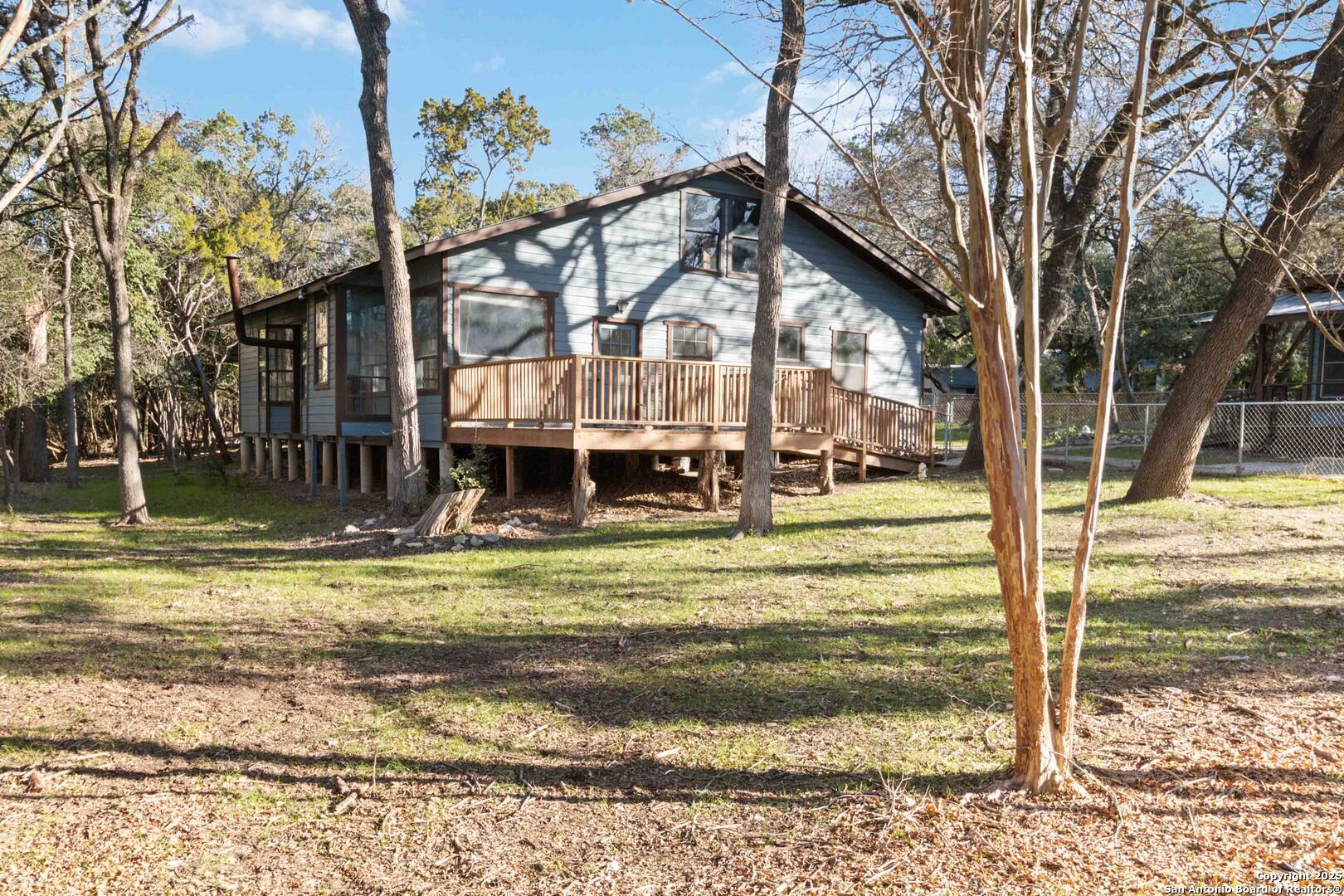 19517 Scenic Loop Road Helotes, TX 78023 - Photo 42 of 55 a view of a house with a big yard and large trees