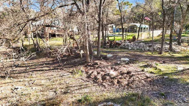 a view of house with a backyard