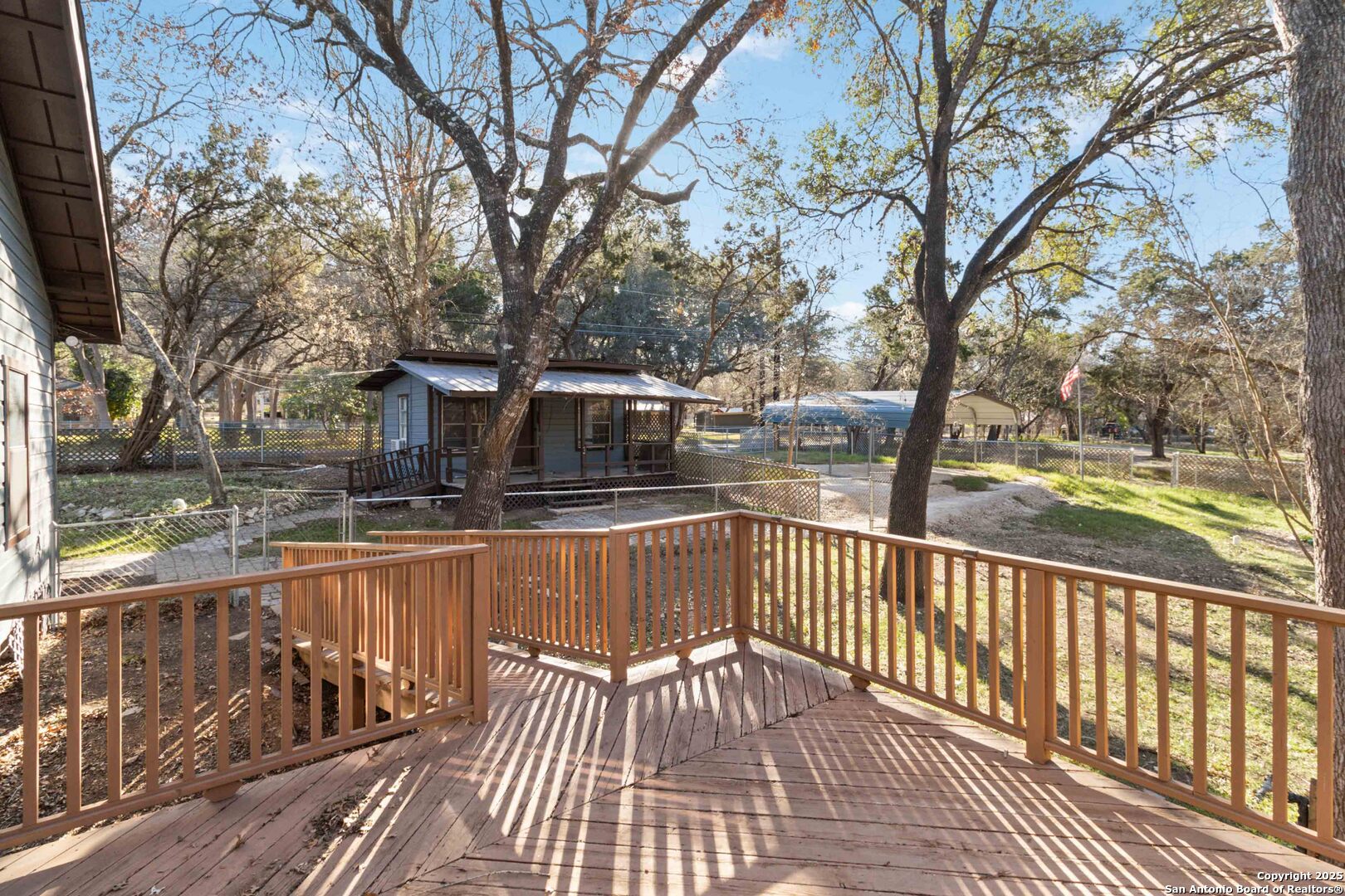 19517 Scenic Loop Road Helotes, TX 78023 - Photo 9 of 55 a view of a wooden deck with a yard