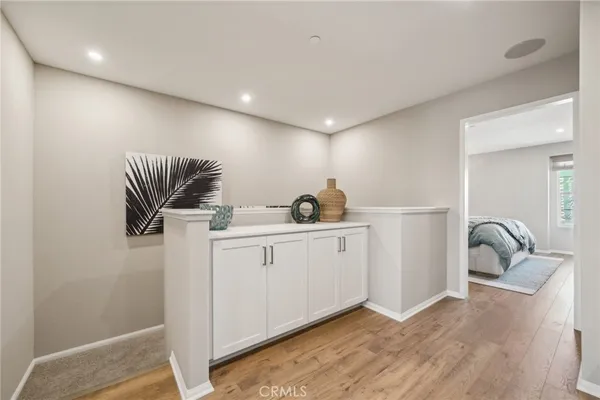 a hall with a sink a couch and dryer