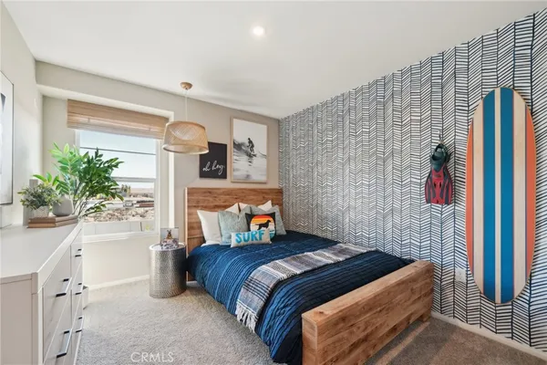 a bedroom with a bed and a potted plant