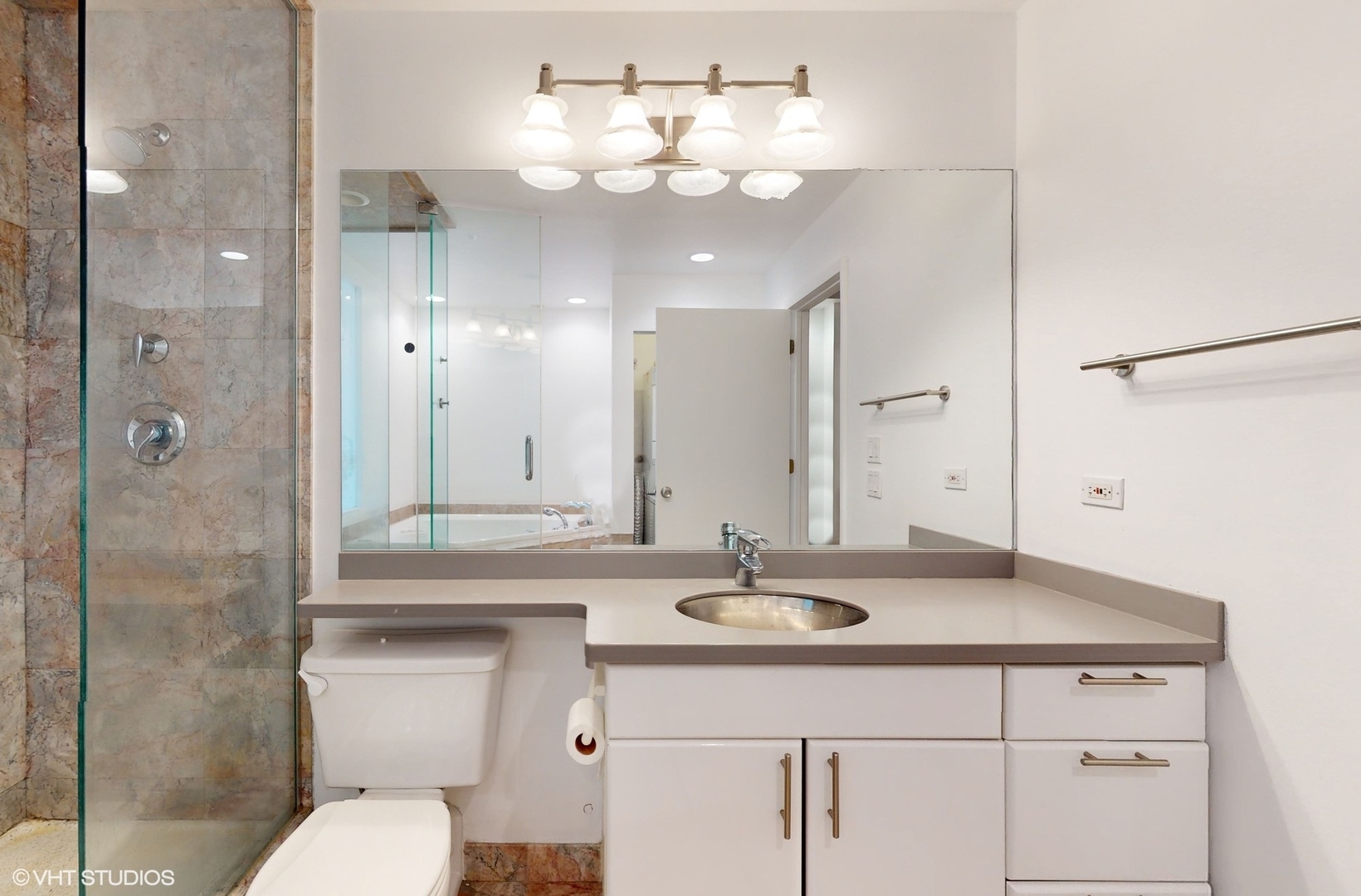616 West Fulton Street, Unit 609 Chicago, IL 60661 - Photo 12 of 23 a bathroom with a sink a toilet and shower