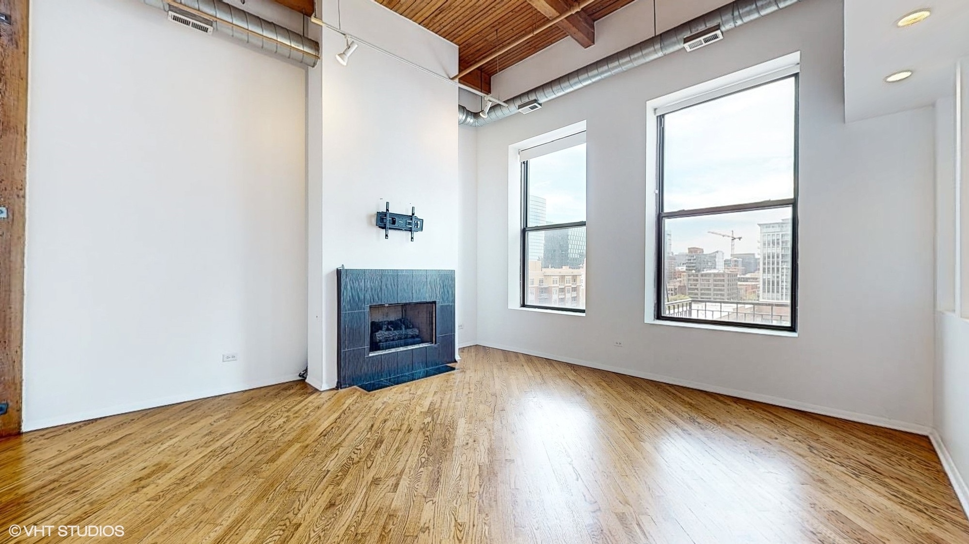 616 West Fulton Street, Unit 609 Chicago, IL 60661 - Photo 18 of 23 an empty room with windows and fireplace