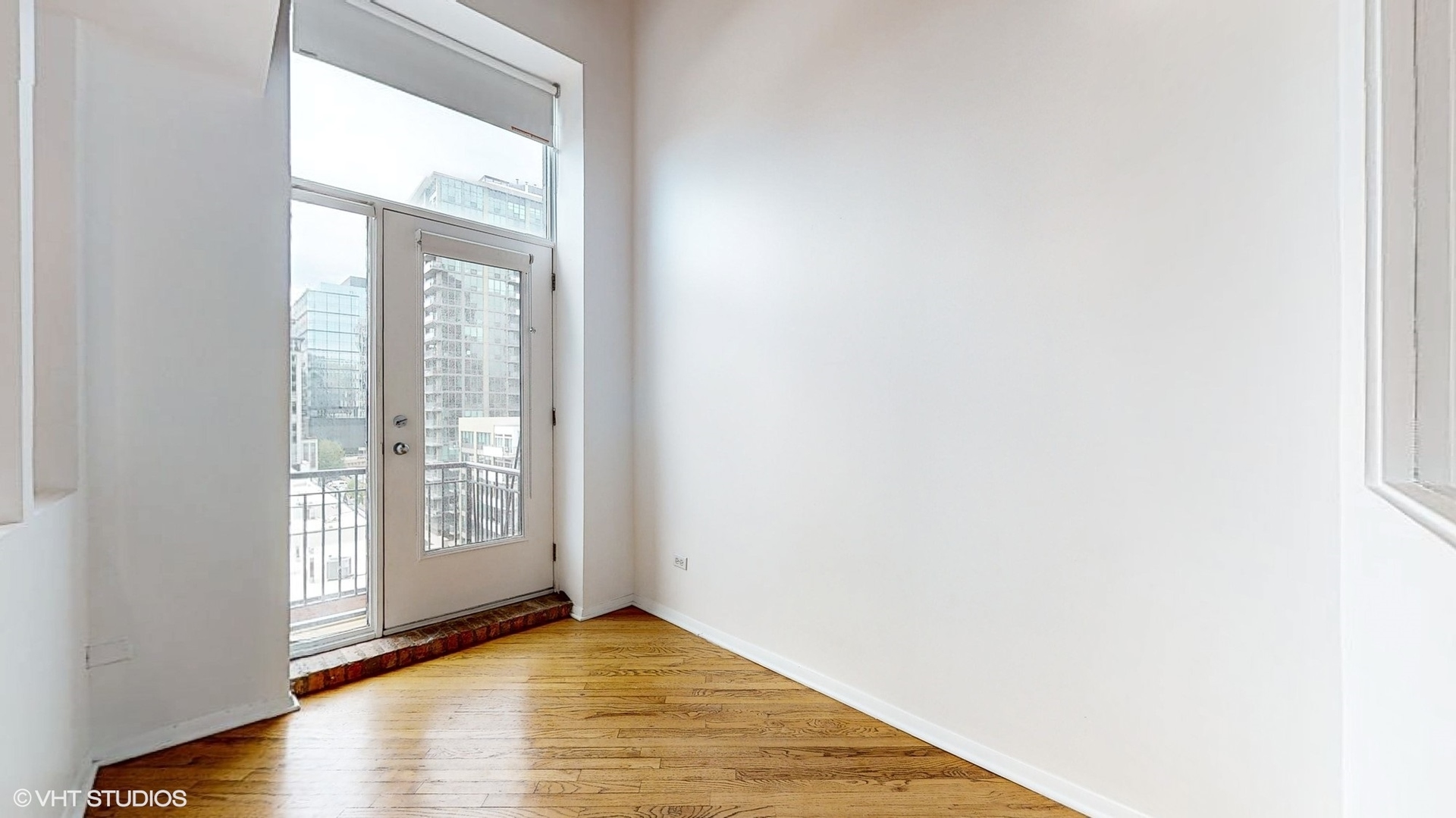 616 West Fulton Street, Unit 609 Chicago, IL 60661 - Photo 20 of 23 an empty room with wooden floor and windows