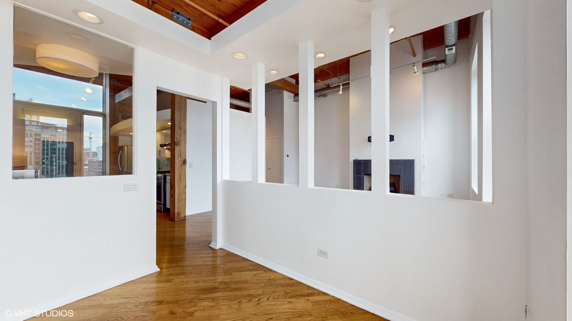 616 West Fulton Street, Unit 609 Chicago, IL 60661 - Photo 21 of 23 a view of a hallway with wooden floor and cabinet