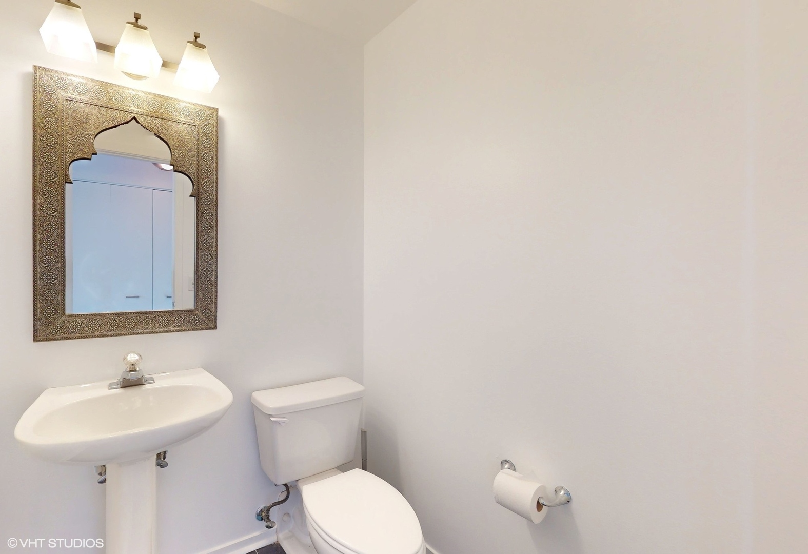 616 West Fulton Street, Unit 609 Chicago, IL 60661 - Photo 5 of 23 a bathroom with a sink a toilet and mirror