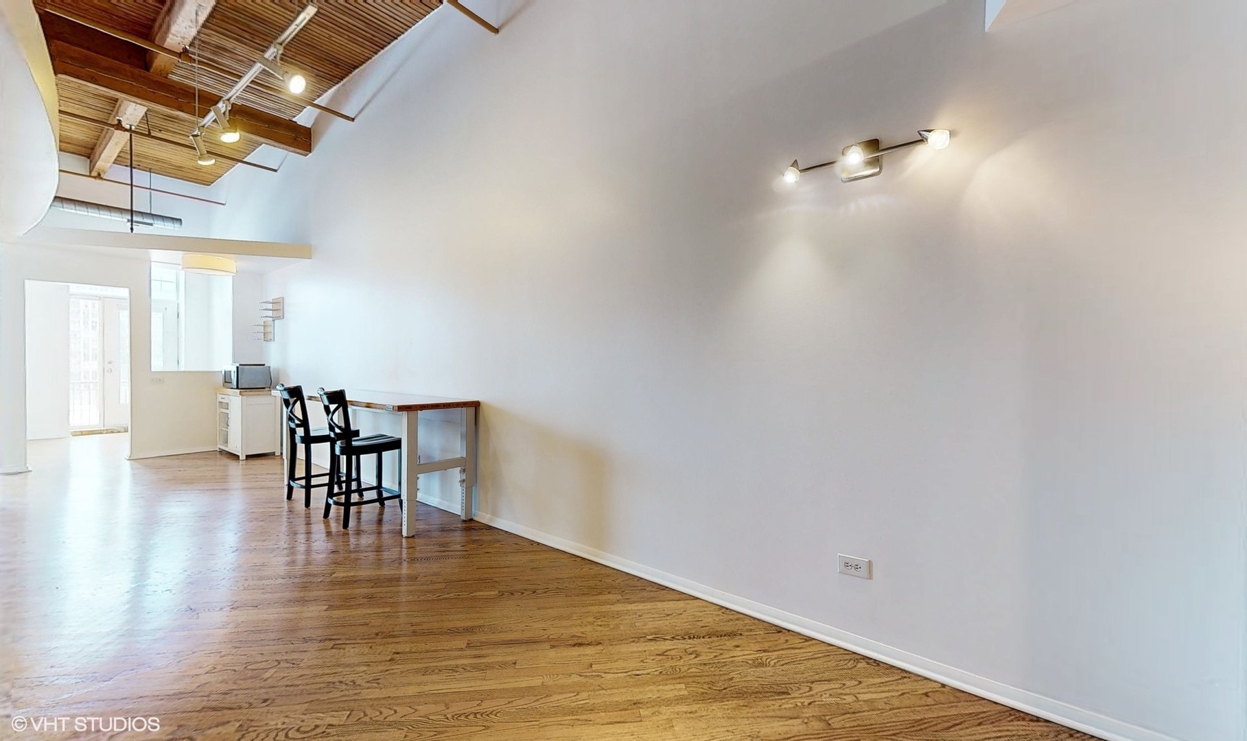 616 West Fulton Street, Unit 609 Chicago, IL 60661 - Photo 8 of 23 a view of a room with wooden floor table and chairs