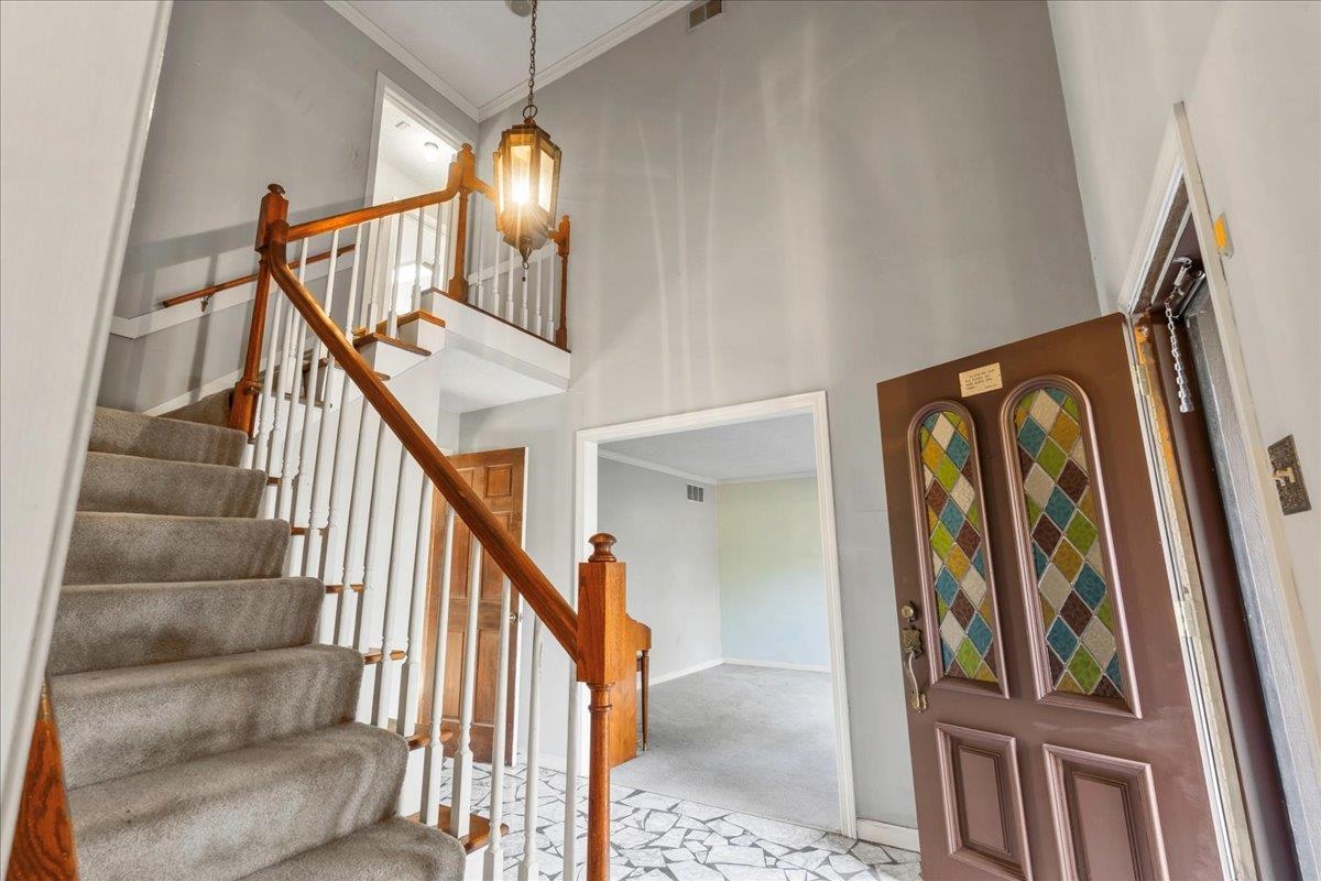 6415 Memphis Arlington Road Bartlett, TN 38135 - Photo 5 of 34 Foyer entrance featuring crown molding, light colored carpet, and a high ceiling