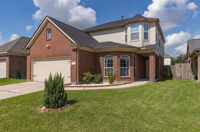a front view of a house with a yard and garage