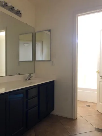 a bathroom with a double vanity sink and mirror