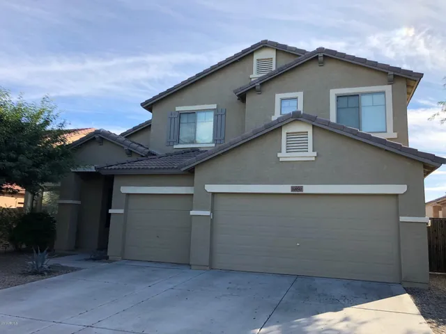 a front view of a house with garage