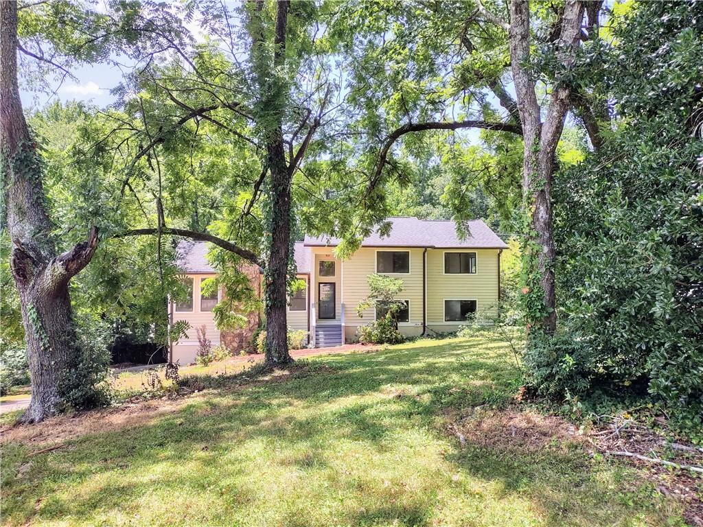 4846 Habersham Ridge Southwest Lilburn, GA 30047 - Photo 1 of 1 a view of a house with a tree in the yard