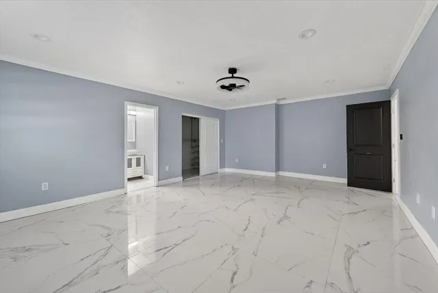 a view of an empty room with a fan