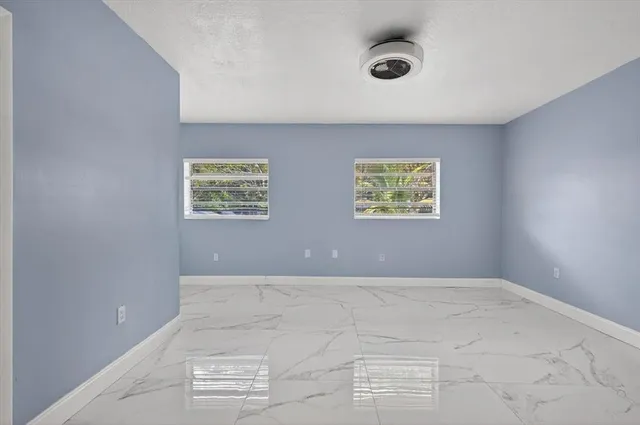 an empty room with windows and windows