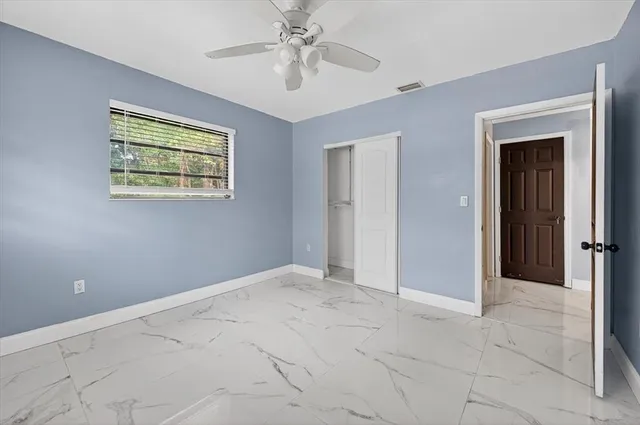 a view of an empty room with a ceiling fan