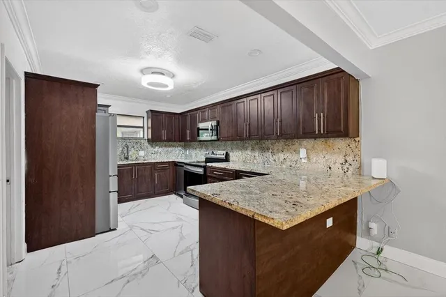 a kitchen with a sink refrigerator and cabinets
