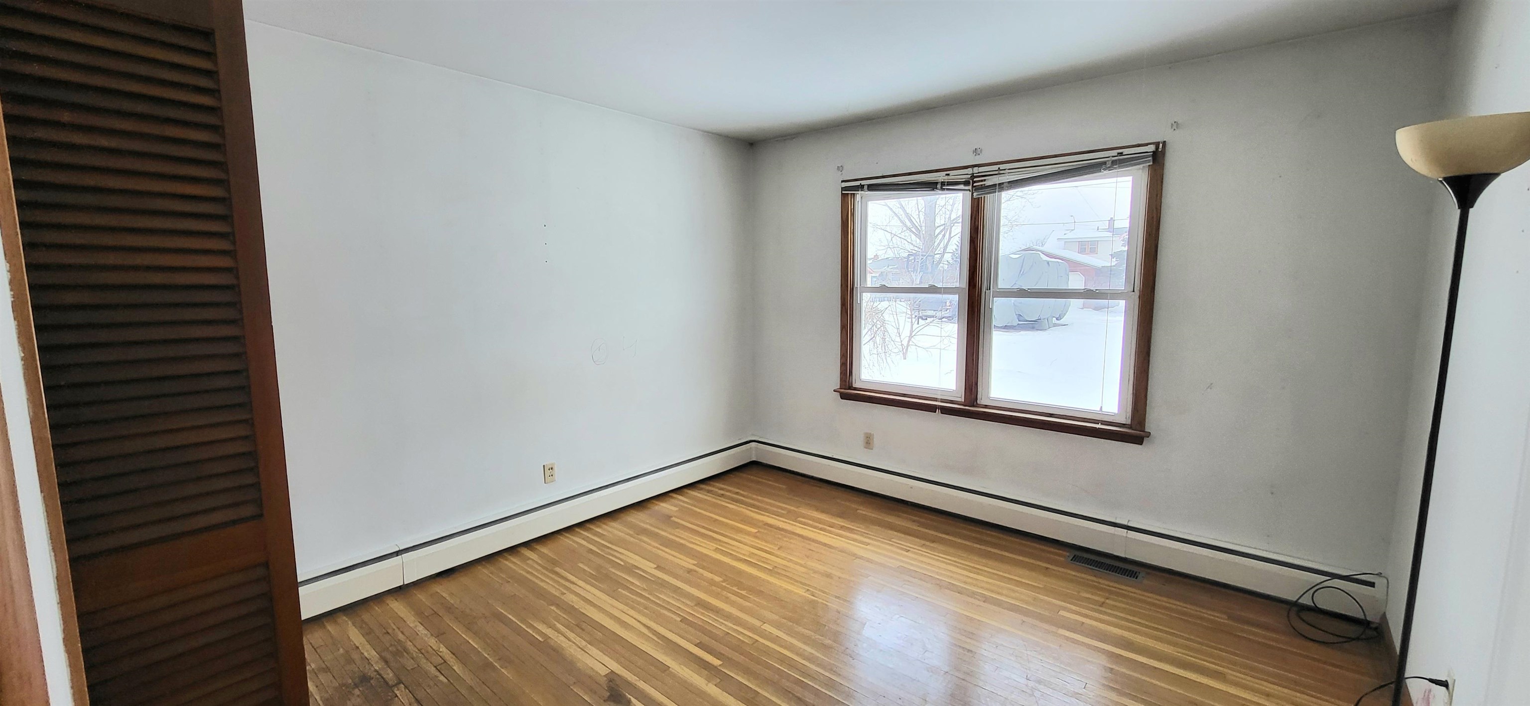 207 East 3rd Street Superior, WI 54880 - Photo 12 of 22 Spare room with light wood-type flooring and baseboard heating