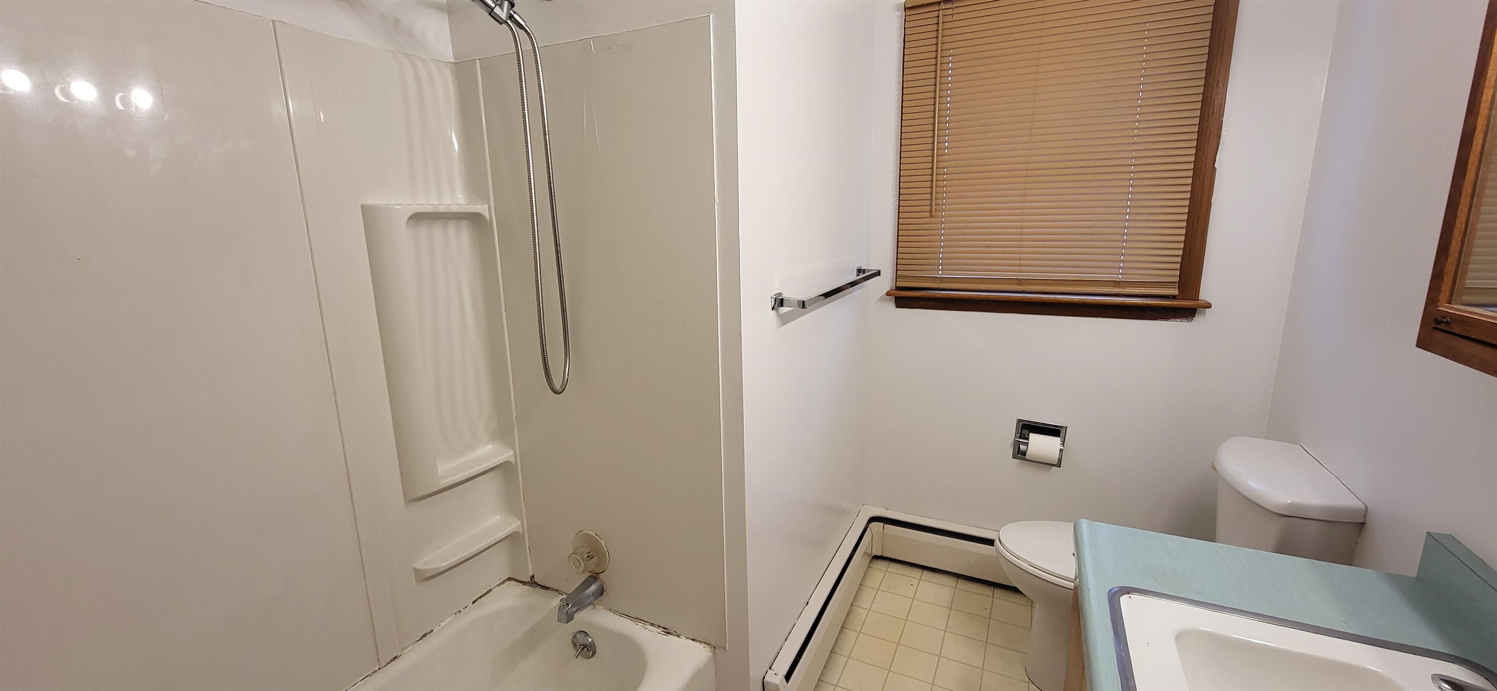 207 East 3rd Street Superior, WI 54880 - Photo 16 of 22 Full bath featuring vanity, shower / washtub combination, and baseboard heating