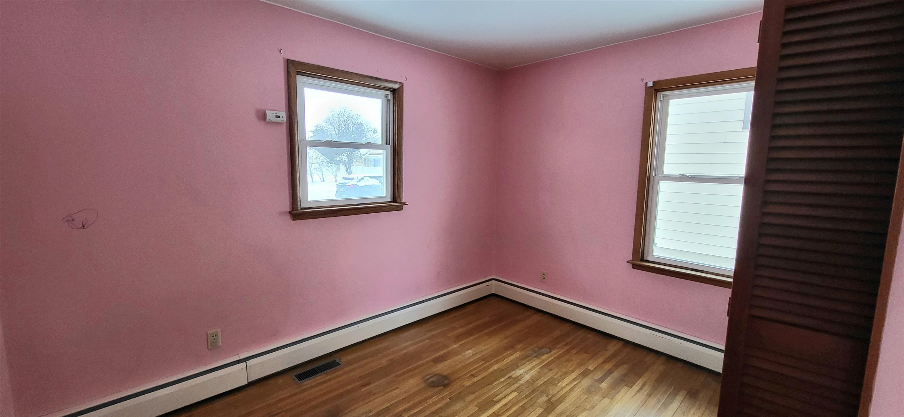 207 East 3rd Street Superior, WI 54880 - Photo 17 of 22 Unfurnished room featuring baseboard heating and wood finished floors