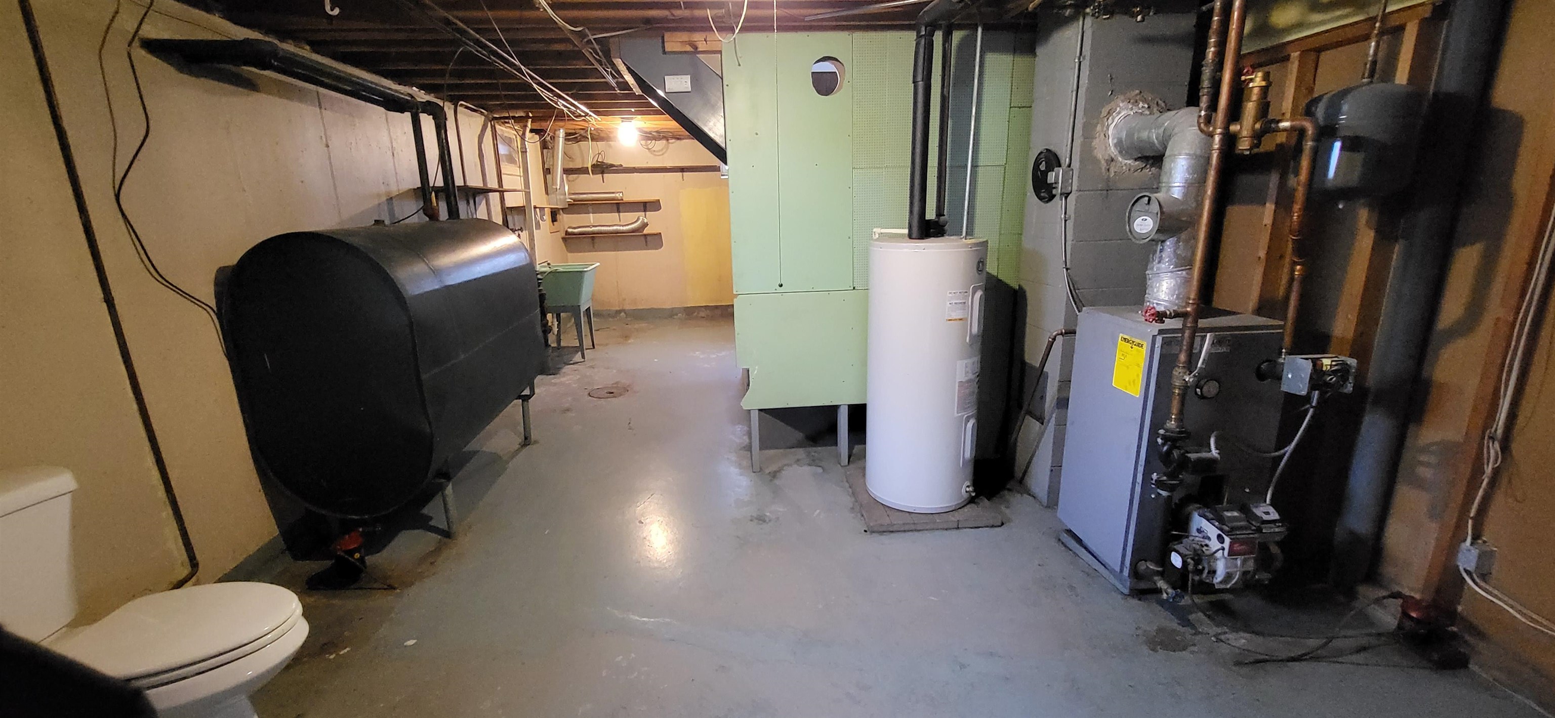 207 East 3rd Street Superior, WI 54880 - Photo 21 of 22 Unfinished below grade area with oil tank, electric water heater, and a heating unit